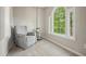 This carpeted sitting area includes a chair next to a window that lets in lots of light at 3267 Standing Peachtree Nw Trl, Kennesaw, GA 30152