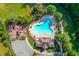 Aerial view of community pool with lounge chairs, playground, and surrounding trees at 4240 Summer Breeze Way, Buford, GA 30518