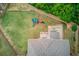 Aerial view of the backyard showcasing playset, deck, patio and lush greenery at 4240 Summer Breeze Way, Buford, GA 30518