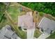 Aerial view of a well-maintained property with a spacious backyard, play area, and lush greenery at 4240 Summer Breeze Way, Buford, GA 30518