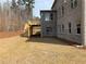 A well-maintained backyard with a deck attached to a brick home at 4240 Summer Breeze Way, Buford, GA 30518