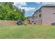 Wide shot of the backyard featuring a playset and expansive lawn space at 4240 Summer Breeze Way, Buford, GA 30518
