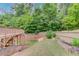 Expansive backyard with a tiered deck and beautifully landscaped garden at 4240 Summer Breeze Way, Buford, GA 30518