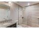 Modern bathroom with glass shower, neutral tile, and granite countertops at 4240 Summer Breeze Way, Buford, GA 30518