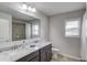 Bathroom boasts dual sinks, granite counters, a separate shower and tub, plus a window at 4240 Summer Breeze Way, Buford, GA 30518