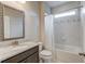 Clean bathroom with granite vanity, neutral tile, and a shower/tub combo with tasteful decorative accent at 4240 Summer Breeze Way, Buford, GA 30518