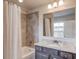 Bathroom features granite counters, gray cabinets, a shower-tub combo, and tile floors at 4240 Summer Breeze Way, Buford, GA 30518