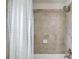 Shower-tub combo with ceramic tile surround, a shower curtain, and modern fixtures at 4240 Summer Breeze Way, Buford, GA 30518