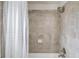 Bathroom includes a tub-shower combo and tiled walls with shower curtain at 4240 Summer Breeze Way, Buford, GA 30518