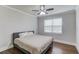 Cozy bedroom features hardwood floors, a large window, and neutral paint, creating a relaxing atmosphere at 4240 Summer Breeze Way, Buford, GA 30518