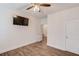 Bedroom featuring neutral paint, wood-look floors, ceiling fan, and mounted TV at 4240 Summer Breeze Way, Buford, GA 30518