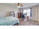 Bedroom features carpet floors, a ceiling fan, a desk, and a bookcase at 4240 Summer Breeze Way, Buford, GA 30518