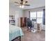 Well-lit bedroom featuring a ceiling fan, and a dedicated workspace with a desk and comfortable chair at 4240 Summer Breeze Way, Buford, GA 30518