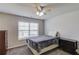 Bedroom features a window, ceiling fan, carpet, and a chest of drawers at 4240 Summer Breeze Way, Buford, GA 30518