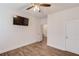 Well-lit bedroom featuring a ceiling fan, television, and a convenient closet at 4240 Summer Breeze Way, Buford, GA 30518