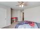 Bedroom includes gray carpet, storage, and a ceiling fan with a light fixture at 4240 Summer Breeze Way, Buford, GA 30518