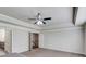 Open bedroom with carpet, trey ceiling with ceiling fan, and access to bathroom at 4240 Summer Breeze Way, Buford, GA 30518