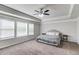 Spacious bedroom featuring tray ceiling, carpet, ceiling fan, and windows for ample natural light at 4240 Summer Breeze Way, Buford, GA 30518