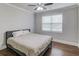 Minimalist bedroom with a large window, a plush bed, and hardwood floors at 4240 Summer Breeze Way, Buford, GA 30518