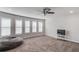 Upstairs bonus room with carpet, natural light and ceiling fan with a television and beanbag chair at 4240 Summer Breeze Way, Buford, GA 30518