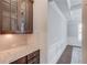 View of butler's pantry featuring elegant cabinetry, countertop space, tiled backsplash, and trim work at 4240 Summer Breeze Way, Buford, GA 30518
