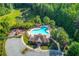 Aerial shot of the community pool surrounded by lush greenery, seating and a playground at 4240 Summer Breeze Way, Buford, GA 30518