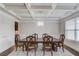 Spacious dining room featuring a coffered ceiling, chandelier, and an oversized dark wood dining table with seating at 4240 Summer Breeze Way, Buford, GA 30518