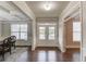 Elegant entryway with hardwood floors, coffered ceilings, and an open view through glass double doors at 4240 Summer Breeze Way, Buford, GA 30518