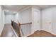 Second floor hallway with wood flooring, iron and wood railing, leading to the bedrooms and bathrooms at 4240 Summer Breeze Way, Buford, GA 30518