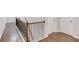 Second floor hallway with hardwood floors and wood railing with metal spindles at 4240 Summer Breeze Way, Buford, GA 30518