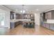 Expansive kitchen features stainless steel appliances, large island with seating, and abundant cabinet space at 4240 Summer Breeze Way, Buford, GA 30518