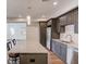 Modern kitchen with dark cabinets, stainless steel appliances, granite countertops and a center island at 4240 Summer Breeze Way, Buford, GA 30518