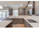 Gourmet kitchen with stainless steel appliances, granite countertops, gas range, and ample cabinet space at 4240 Summer Breeze Way, Buford, GA 30518
