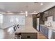 Bright kitchen with granite countertop island, stainless steel appliances, and open layout to living area at 4240 Summer Breeze Way, Buford, GA 30518