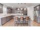 This open kitchen features stainless steel appliances, granite countertops, and a large island with barstool seating at 4240 Summer Breeze Way, Buford, GA 30518