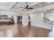 Open concept living room featuring coffered ceilings, hardwood floors, and seamless flow into kitchen and stairway at 4240 Summer Breeze Way, Buford, GA 30518