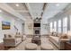Spacious living room with a stone fireplace, coffered ceilings, and built-in shelving at 4240 Summer Breeze Way, Buford, GA 30518