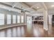Spacious open-concept area featuring hardwood flooring, coffered ceilings, and an adjacent kitchen with bar seating at 4240 Summer Breeze Way, Buford, GA 30518