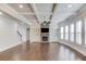 Bright living room with a stone fireplace, coffered ceilings, and hardwood flooring at 4240 Summer Breeze Way, Buford, GA 30518