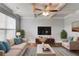 Inviting living room featuring coffered ceilings, neutral furniture, and natural light from the bright windows at 4240 Summer Breeze Way, Buford, GA 30518