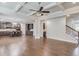 Open-concept living room with hardwood floors and views of the kitchen and staircase at 4240 Summer Breeze Way, Buford, GA 30518