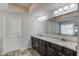 Main bathroom boasting double vanity sinks, granite countertops, and modern lighting fixtures above the mirror at 4240 Summer Breeze Way, Buford, GA 30518