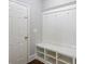 Welcoming mudroom featuring built-in bench, storage cubbies, and convenient coat hooks at 4240 Summer Breeze Way, Buford, GA 30518