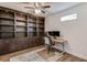 Office with custom built-in bookcase and storage cabinets, desk and nice lighting at 4240 Summer Breeze Way, Buford, GA 30518