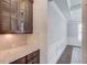 Pantry features tiled backsplash and custom cabinetry, adjacent to the hallway at 4240 Summer Breeze Way, Buford, GA 30518