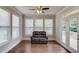 Cozy sunroom with large windows, French doors to the outside, and a comfortable loveseat at 4240 Summer Breeze Way, Buford, GA 30518