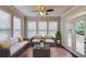 Bright sunroom with large windows, comfortable seating, and access to the outdoor deck at 4240 Summer Breeze Way, Buford, GA 30518