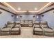 A cozy theater room equipped with tiered seating, comfortable leather chairs, and a projector system at 4240 Summer Breeze Way, Buford, GA 30518