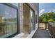 A balcony with metal railings and a view of green trees beyond the sliding glass door at 533 Rubato Knl, Mcdonough, GA 30253