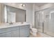 Bathroom featuring double sinks, a large mirror, and a glass-enclosed shower at 533 Rubato Knl, Mcdonough, GA 30253